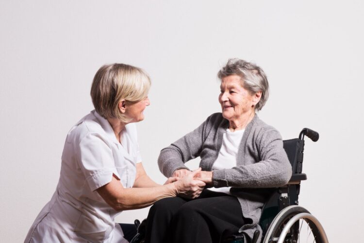 studio-portrait-of-a-senior-nurse-and-an-elderly-YBR2W8D-min