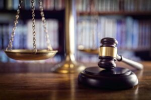 Judge gavel, scales of justice and law books in court Judge gavel, scales of justice and law books in court